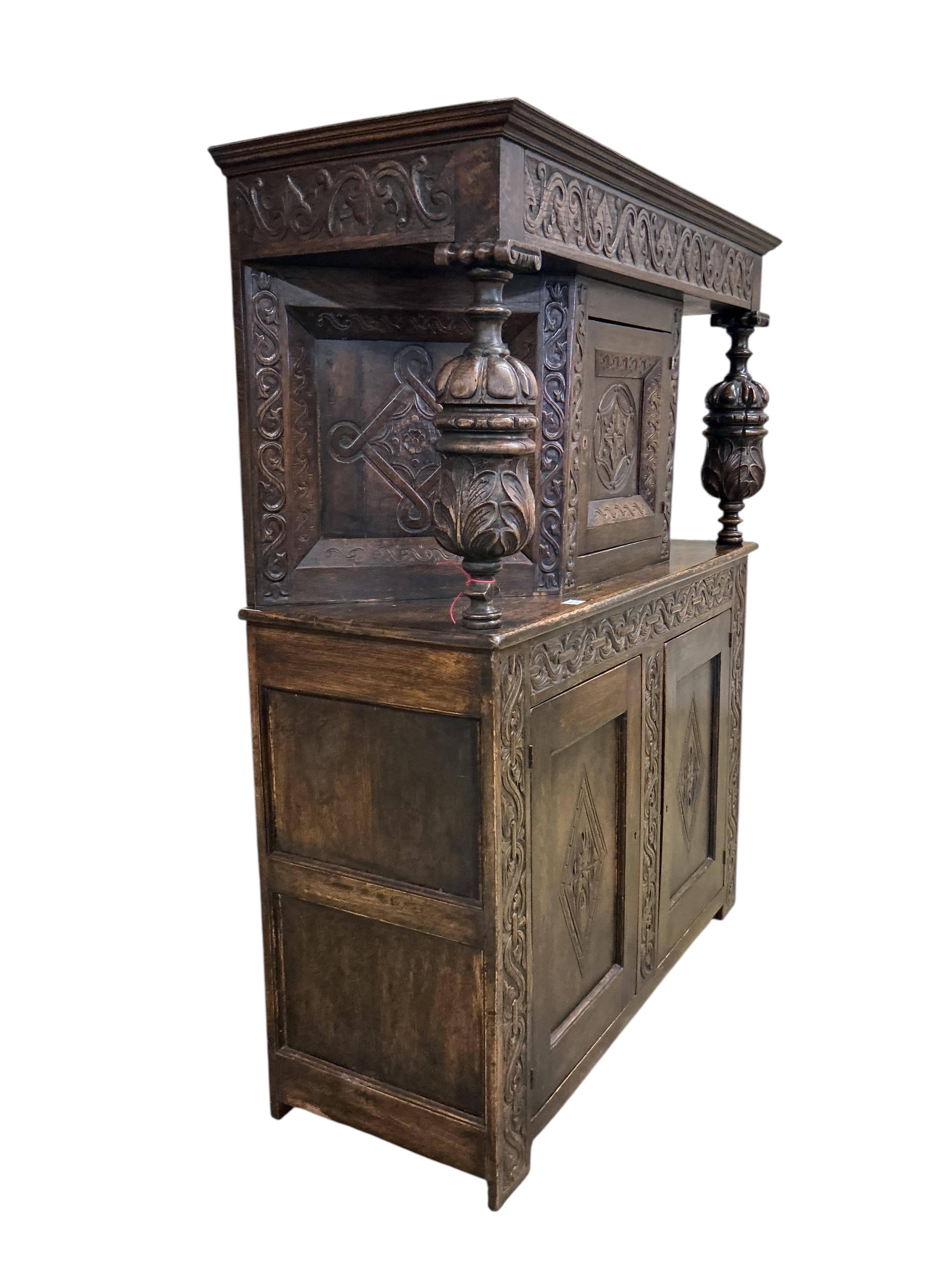 A 17th century style carved oak court cupboard, width 142cm, depth 53cm, height 176cm